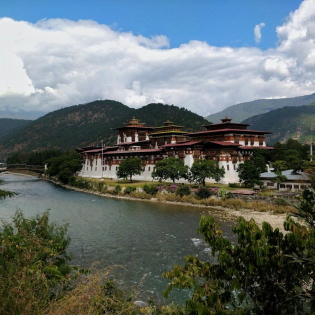 white and brown concrete house near body of water